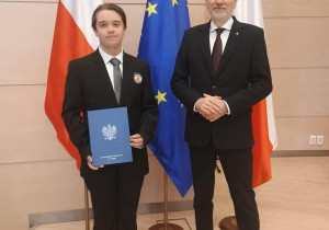 Uczeń klasy siódmej na zdjęciu z panem kuratorem