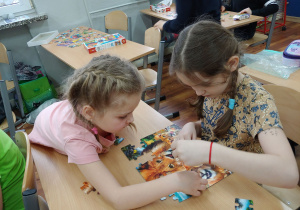 Dzieci współpracują podczas układania puzzli